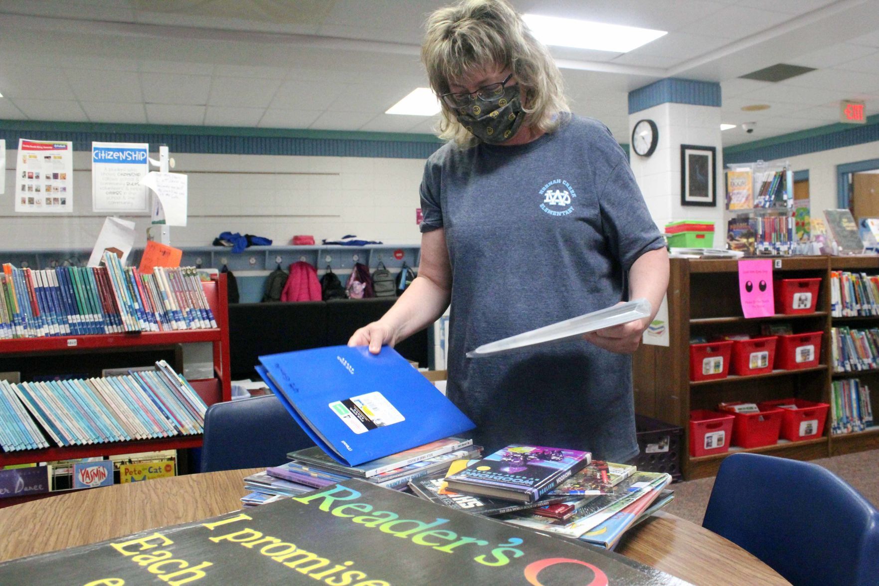 Rae Ann Schulz organizes books 2